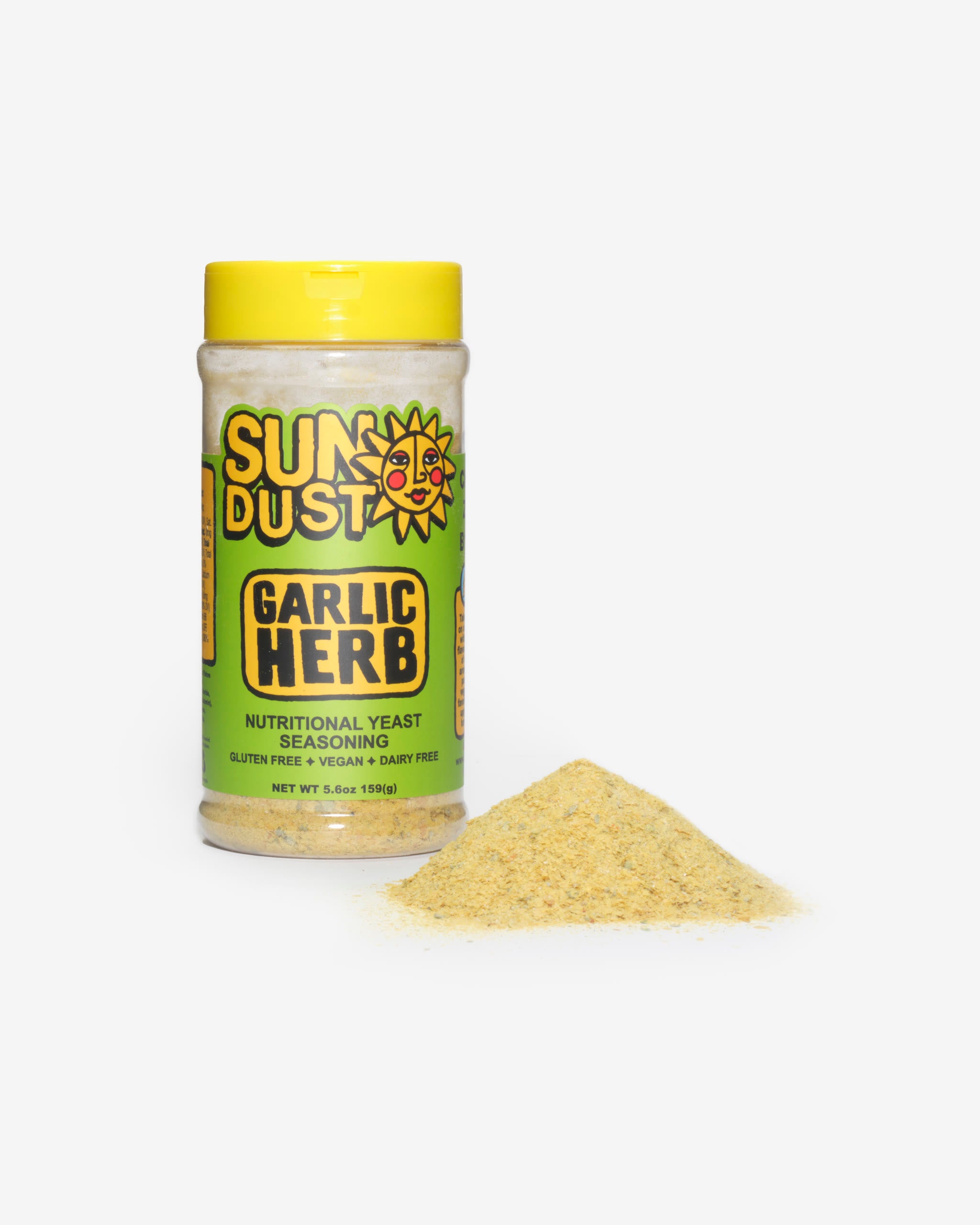 Sun Dust Garlic Herb jar beside a mound of savory nutritional yeast seasoning