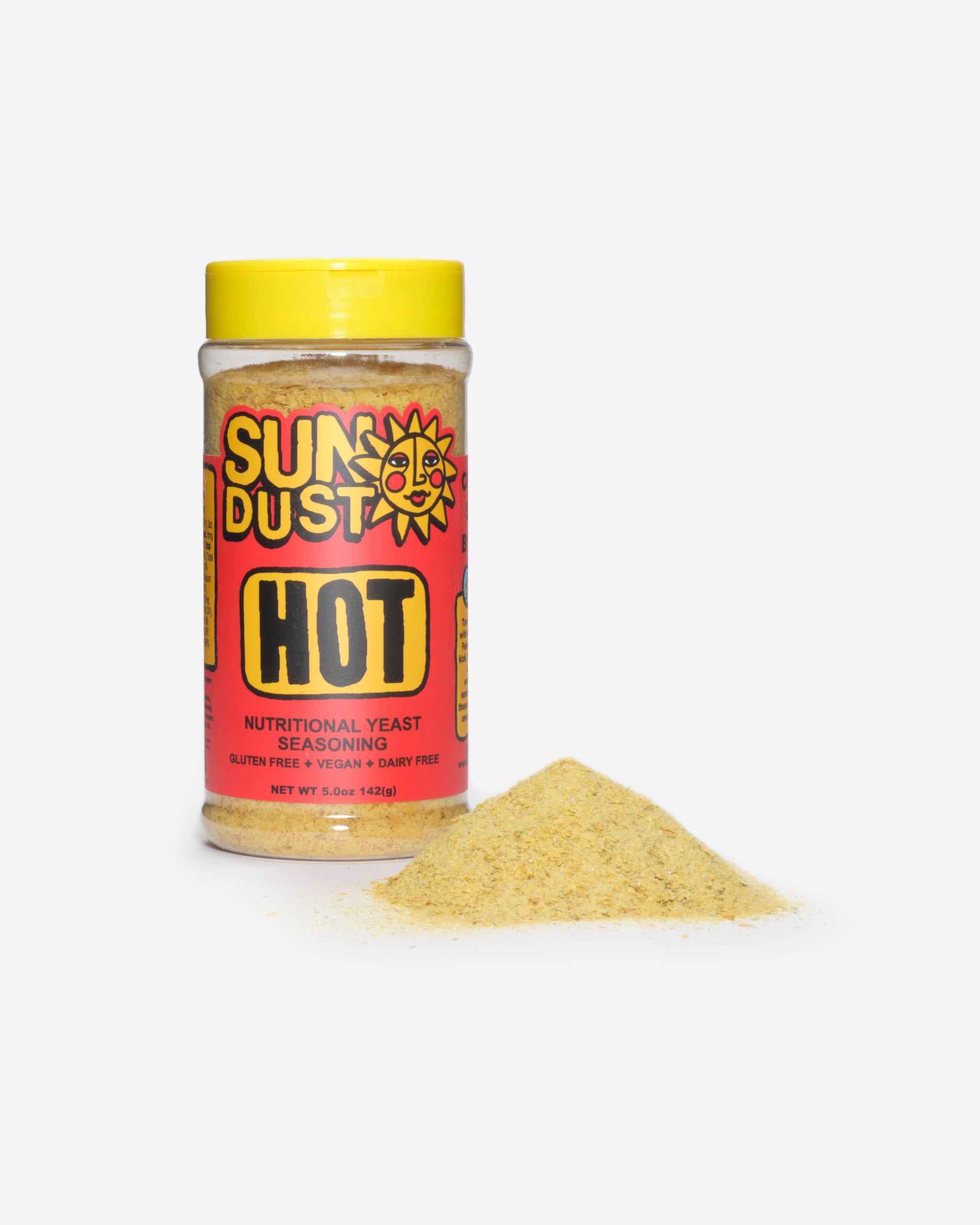 Sun Dust Hot jar beside a mound of spicy nutritional yeast seasoning